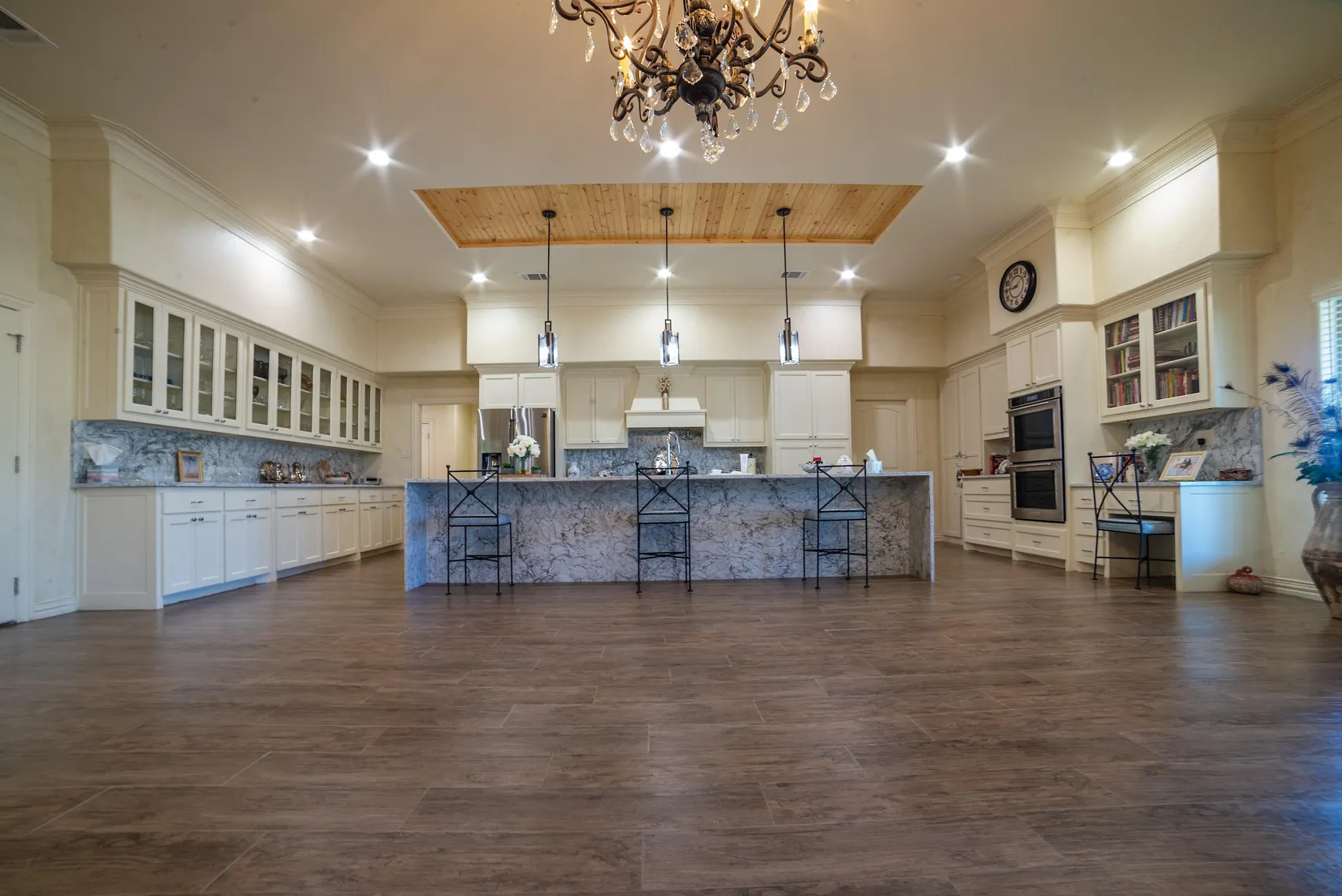 Chef's kitchen with marble island and chandelier