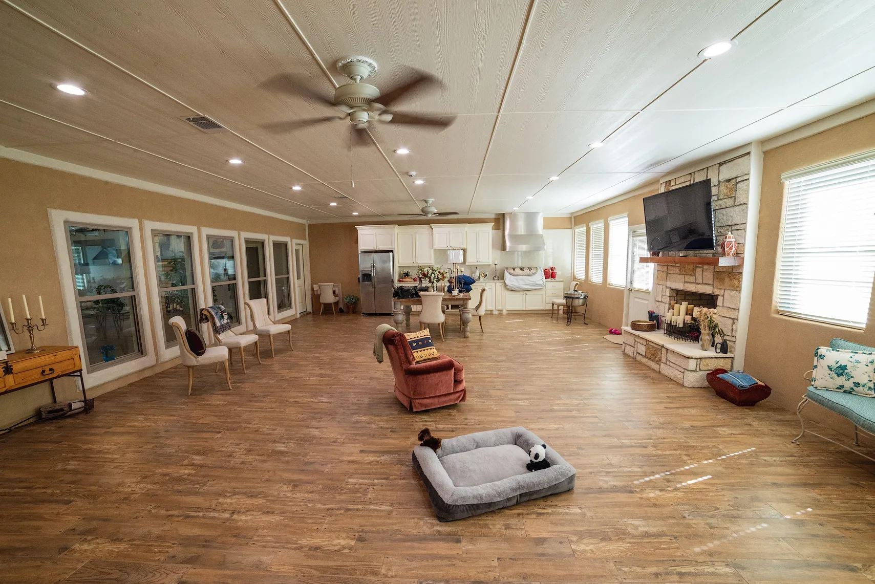 Climate-controlled back porch and game room with stone fireplace