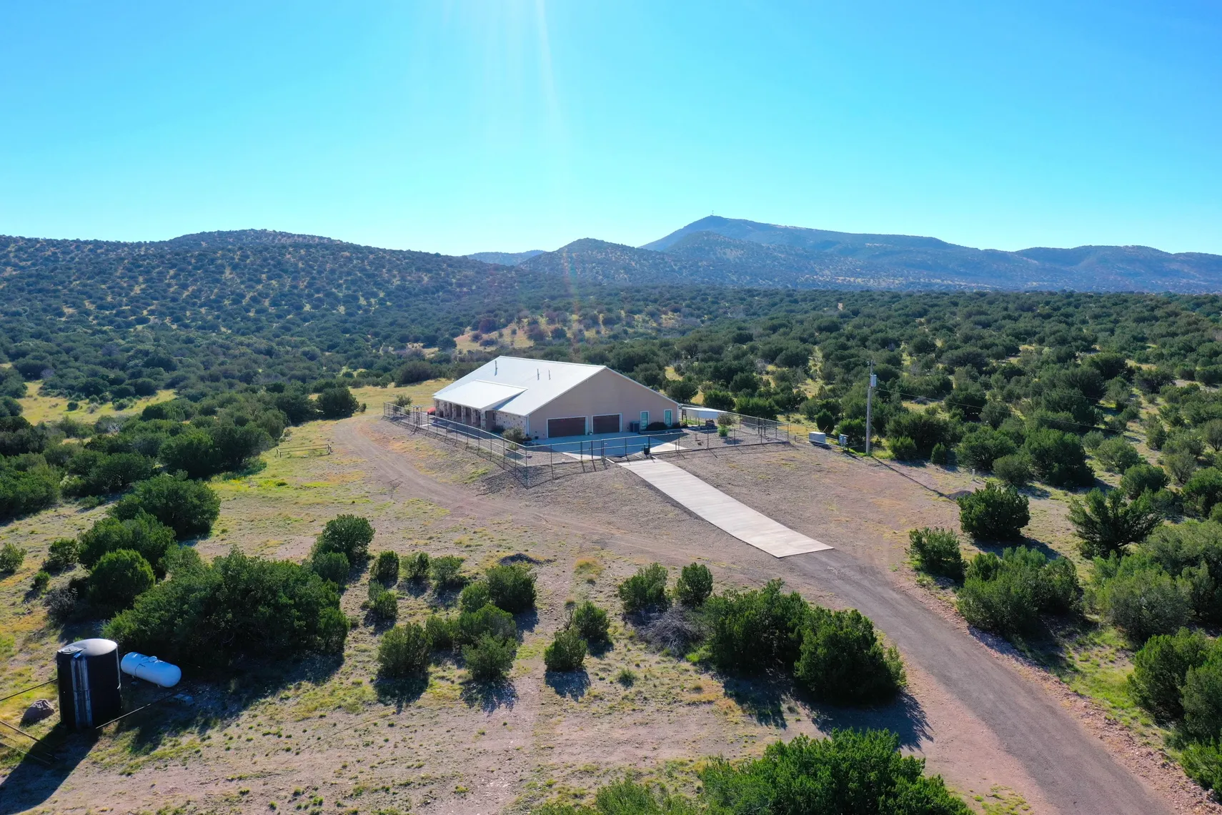 Aerial east view of the home and drive