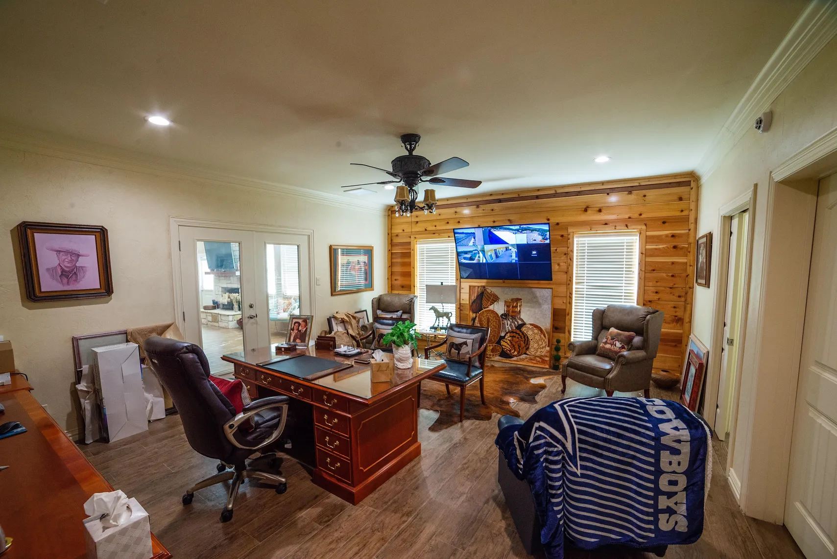 Home office with cedar accent wall and ranch security monitors