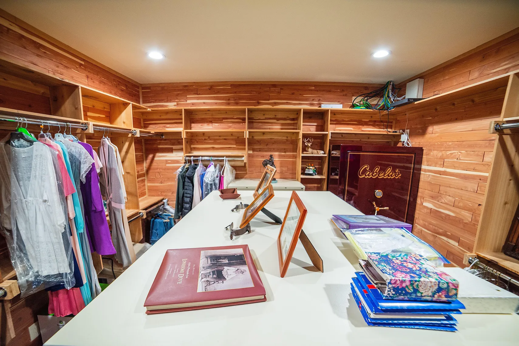 Cedar-lined guest closet with built-in cabinetry and gun safe