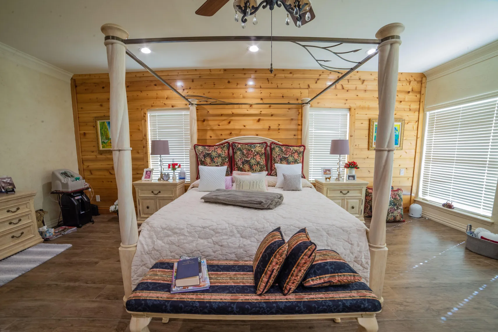 Primary suite facing the canopy bed and chandelier