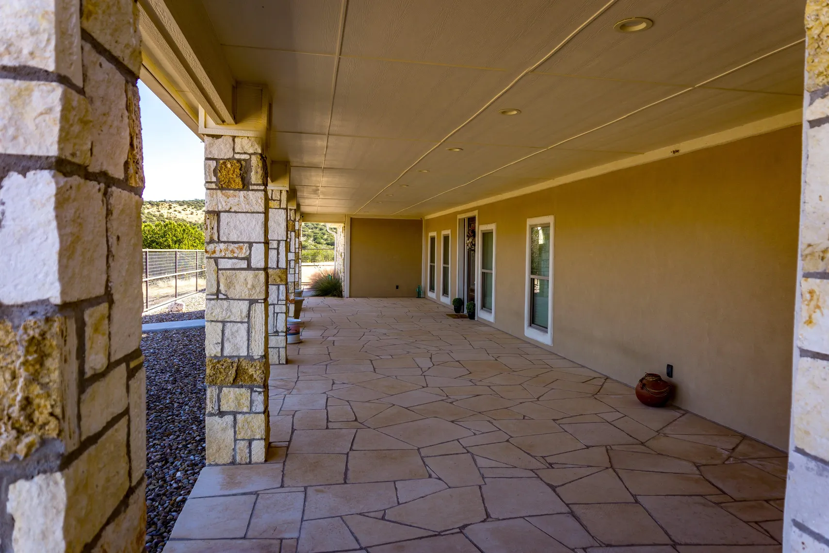 Wraparound flagstone porch with stone columns
